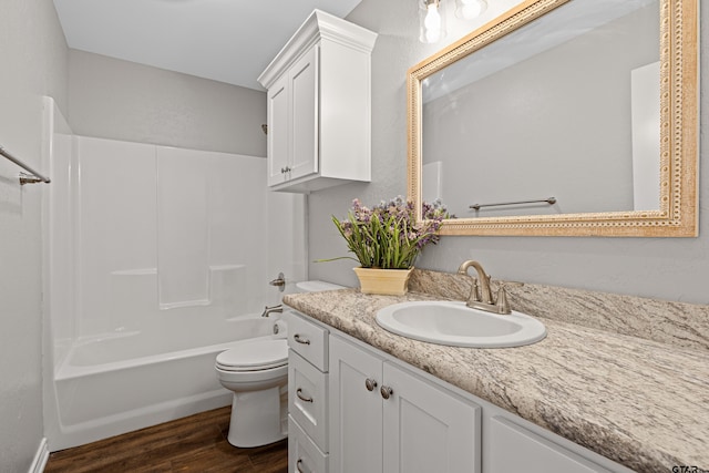 full bathroom featuring vanity, hardwood / wood-style flooring, shower / bathtub combination, and toilet