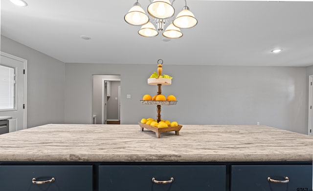 kitchen featuring light countertops, an inviting chandelier, recessed lighting, and blue cabinetry