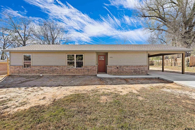 view of front facade with a carport and a front lawn