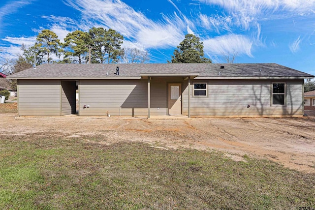 back of house with a lawn