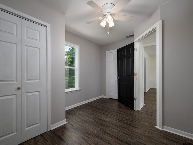 501 S Railroad St, Troup, TX 75789 - unfurnished bedroom with dark wood finished floors and ceiling fan