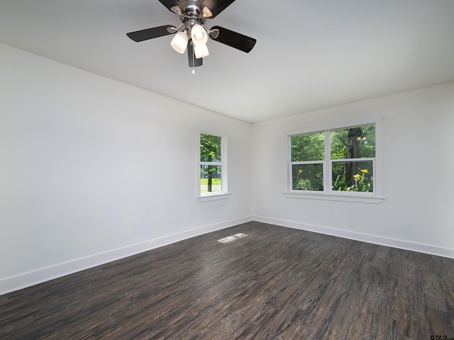 501 S Railroad St, Troup, TX 75789 - spare room with dark wood-style floors and a ceiling fan