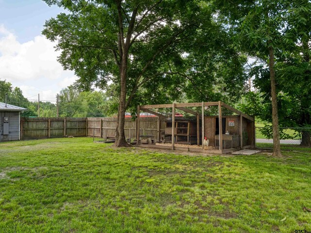 501 S Railroad St, Troup, TX 75789 - fenced backyard featuring exterior structure and an outbuilding