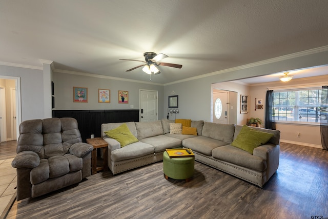 living room featuring dark hardwood / wood-style floors, ceiling fan, and crown molding