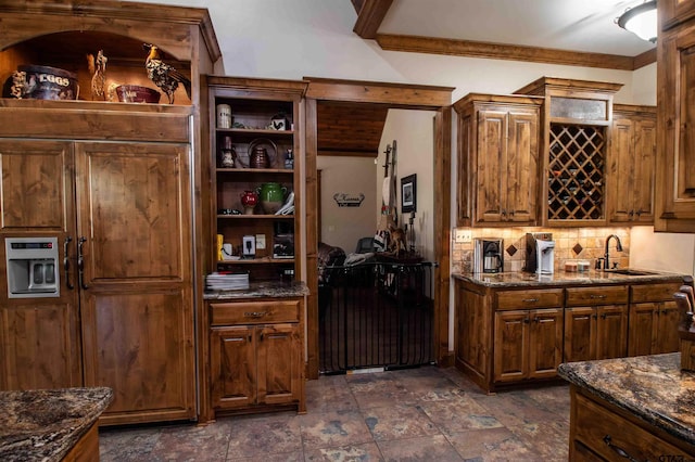 14647 County Road 2337, Tyler, TX 75707 - kitchen with dark stone counters, open shelves, stone finish flooring, a sink, and decorative backsplash