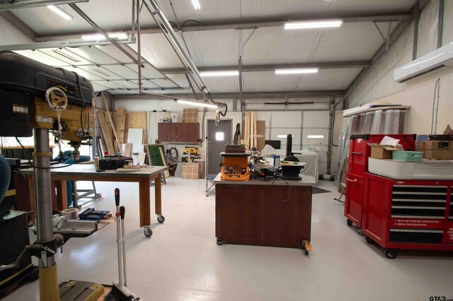 14647 County Road 2337, Tyler, TX 75707 - garage featuring a wall mounted air conditioner and a workshop area