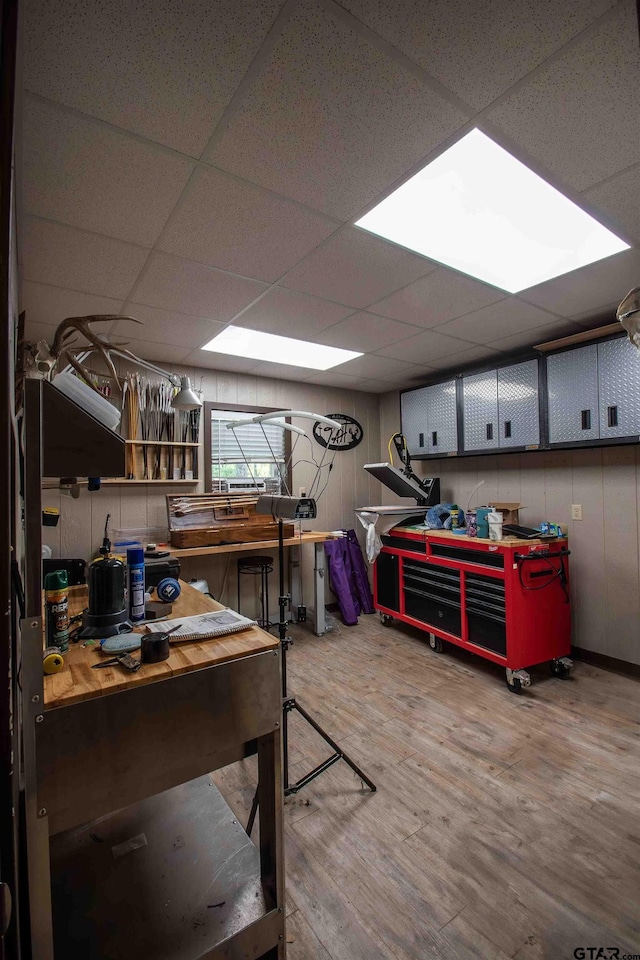 14647 County Road 2337, Tyler, TX 75707 - misc room featuring a paneled ceiling, wood finished floors, and a workshop area