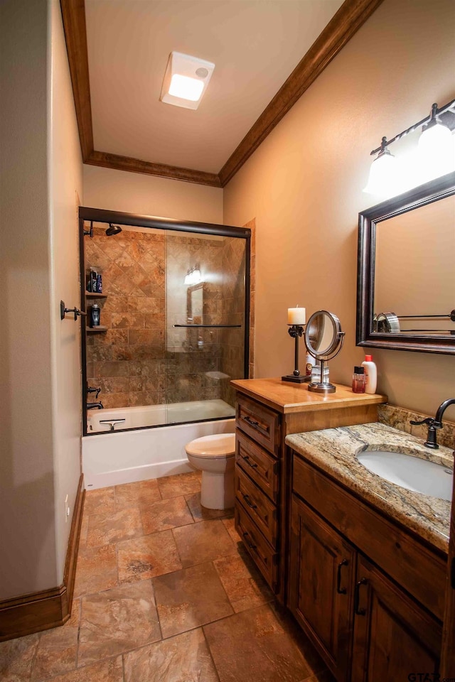 14647 County Road 2337, Tyler, TX 75707 - bathroom featuring toilet, crown molding, vanity, stone tile floors, and shower / bath combination with glass door