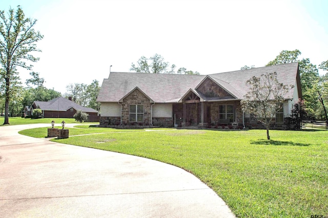 14647 County Road 2337, Tyler, TX 75707 - view of front facade with concrete driveway, stone siding, and a front lawn