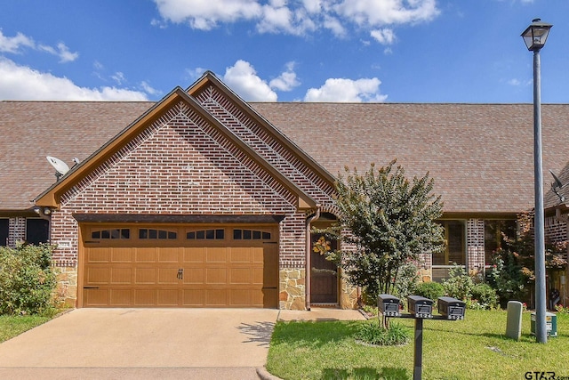 view of front of home with a garage and a front yard