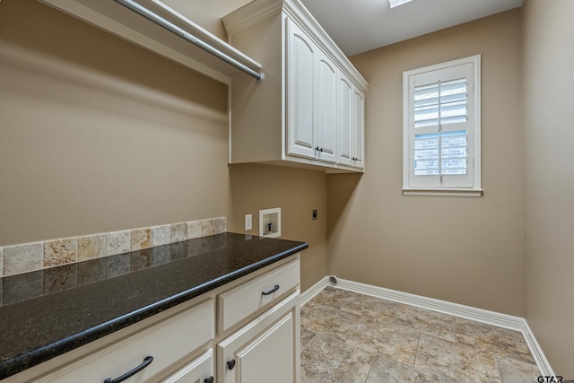laundry area featuring hookup for an electric dryer, baseboards, hookup for a washing machine, and cabinet space
