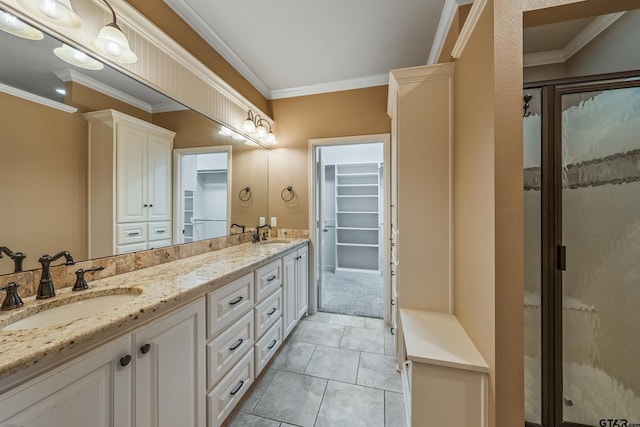 bathroom featuring crown molding, double vanity, a spacious closet, and a shower stall