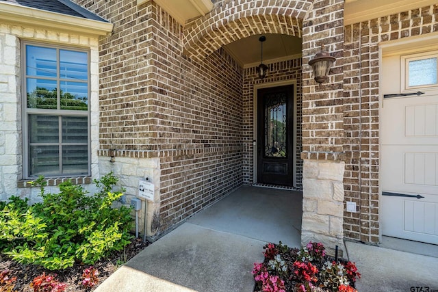 doorway to property with brick siding