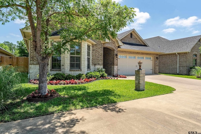 view of front of home featuring stone siding, an attached garage, brick siding, and concrete driveway
