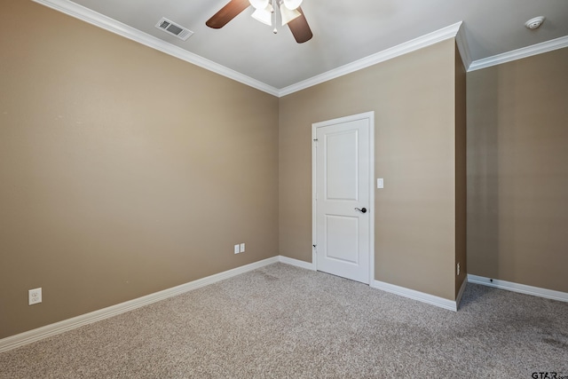 unfurnished room with ceiling fan, carpet, crown molding, baseboards, and a smoke detector