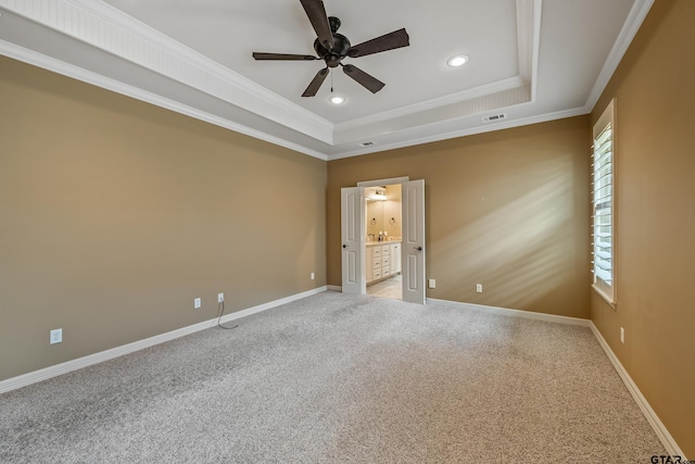 carpeted empty room featuring ceiling fan, a raised ceiling, plenty of natural light, recessed lighting, and crown molding