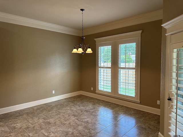 unfurnished room with ornamental molding, baseboards, a chandelier, and dark stone finish floors