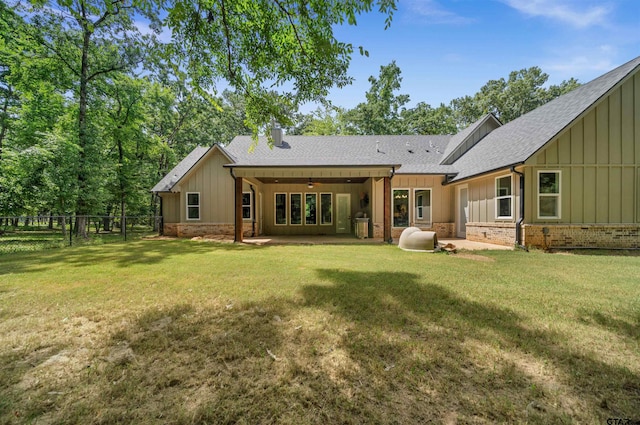 14607 Reserve Ct, Tyler, TX 75707 - back of property with board and batten siding, a ceiling fan, roof with shingles, brick siding, and a patio area