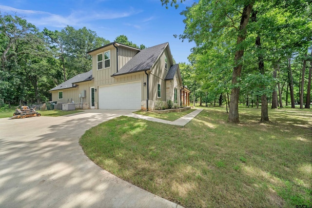 14607 Reserve Ct, Tyler, TX 75707 - view of front of property featuring concrete driveway, an attached garage, a front yard, board and batten siding, and a shingled roof