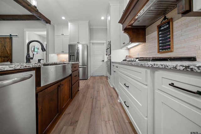 14607 Reserve Ct, Tyler, TX 75707 - kitchen with stainless steel appliances, recessed lighting, light stone countertops, extractor fan, and decorative backsplash
