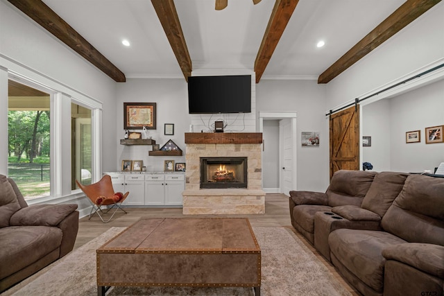 14607 Reserve Ct, Tyler, TX 75707 - living room featuring light wood-type flooring, beam ceiling, a barn door, a fireplace, and recessed lighting