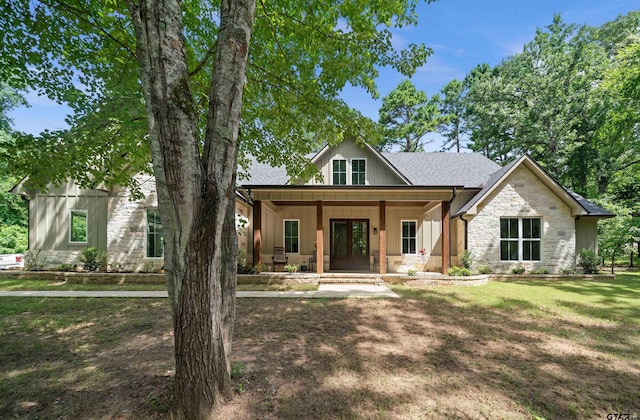 14607 Reserve Ct, Tyler, TX 75707 - modern farmhouse featuring french doors, stone siding, a porch, a front lawn, and a shingled roof