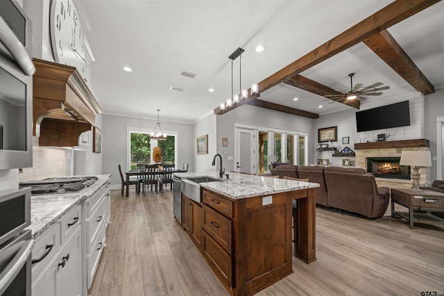 14607 Reserve Ct, Tyler, TX 75707 - kitchen featuring ceiling fan, white cabinets, light wood finished floors, backsplash, and stainless steel appliances