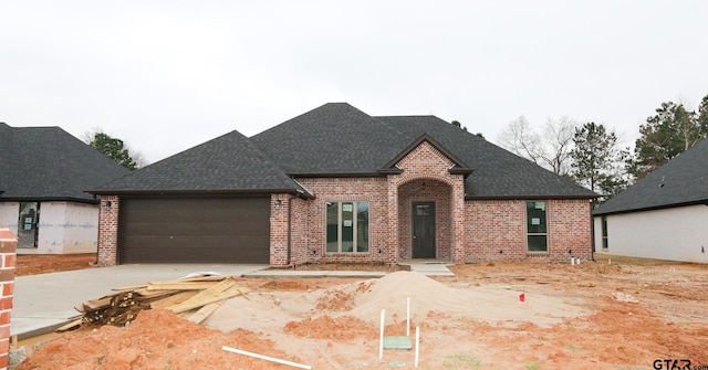 french provincial home with a garage