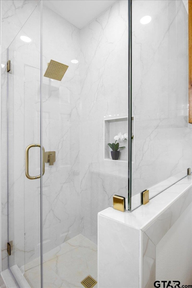 full bath featuring a marble finish shower