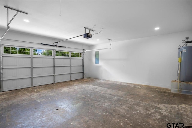 garage with a garage door opener, recessed lighting, and water heater