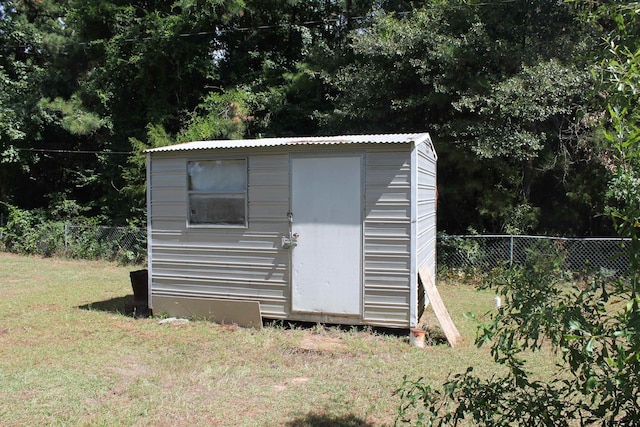 view of outbuilding with a lawn