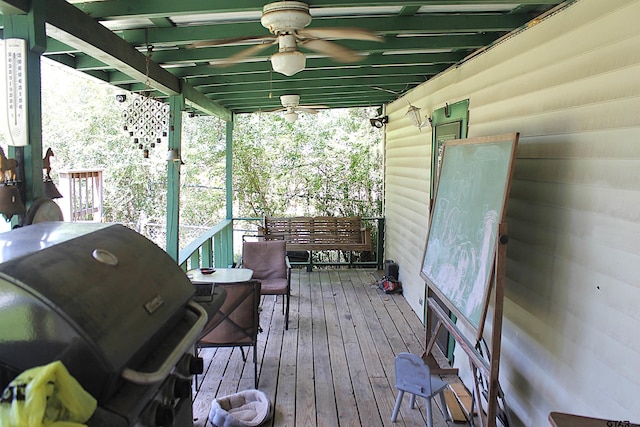 deck with grilling area and ceiling fan