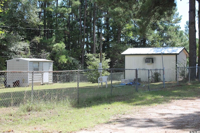 view of yard featuring a wall mounted AC and a shed