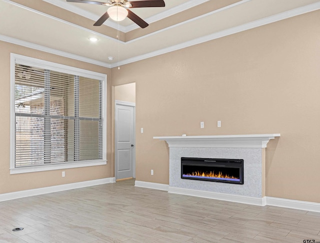 unfurnished living room with ornamental molding, light hardwood / wood-style flooring, and plenty of natural light