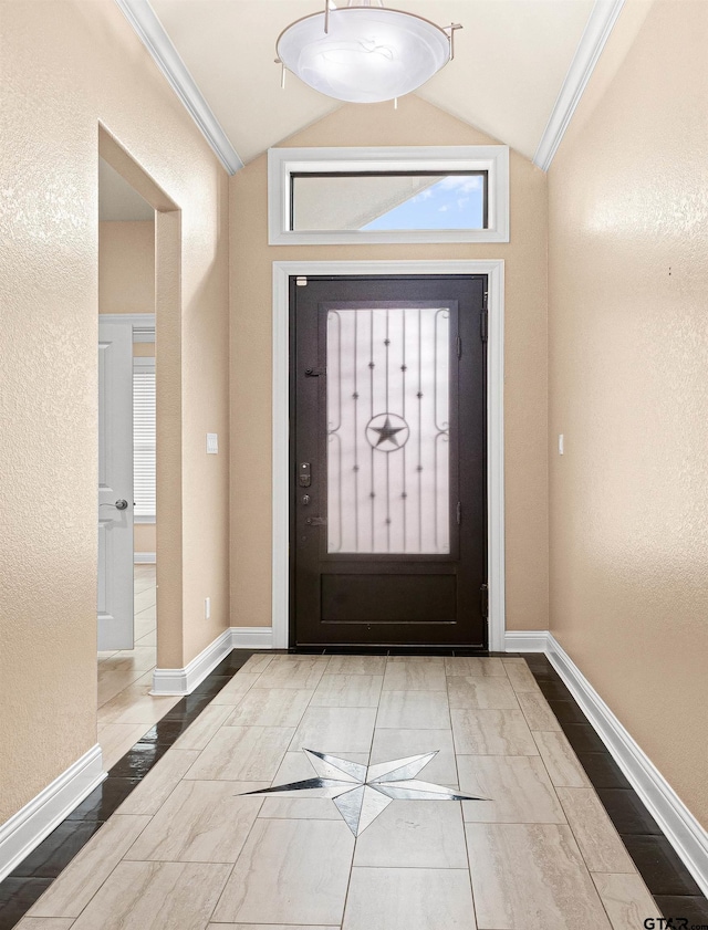 entryway featuring crown molding and vaulted ceiling