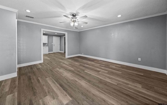 spare room with ceiling fan, crown molding, dark wood-type flooring, and a textured ceiling