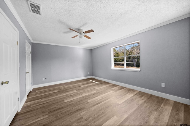 unfurnished room with a textured ceiling, dark hardwood / wood-style flooring, ceiling fan, and crown molding