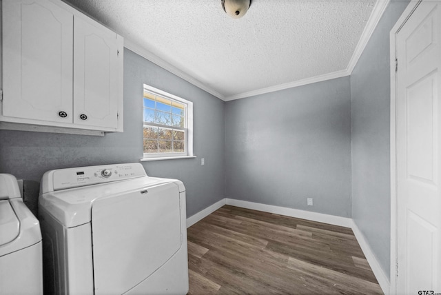 laundry room featuring washing machine and dryer, dark wood-type flooring, cabinets, and a textured ceiling