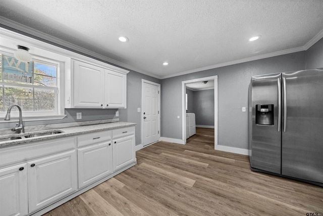 kitchen with white cabinetry, sink, stainless steel fridge with ice dispenser, crown molding, and light wood-type flooring