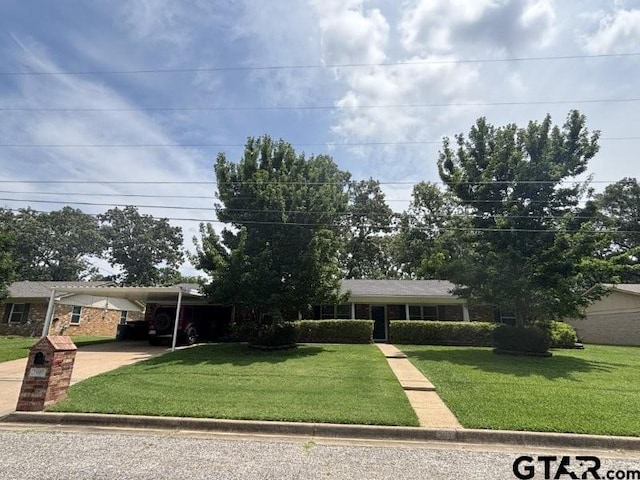 3010 Cook Ln, Longview, TX 75602 - ranch-style house featuring a front lawn, a carport, and driveway