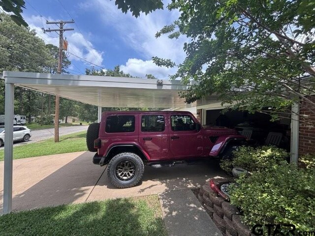 3010 Cook Ln, Longview, TX 75602 - view of vehicle parking featuring concrete driveway and an attached carport