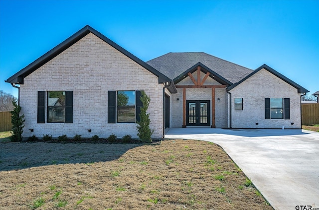 view of front of house featuring french doors and a front lawn