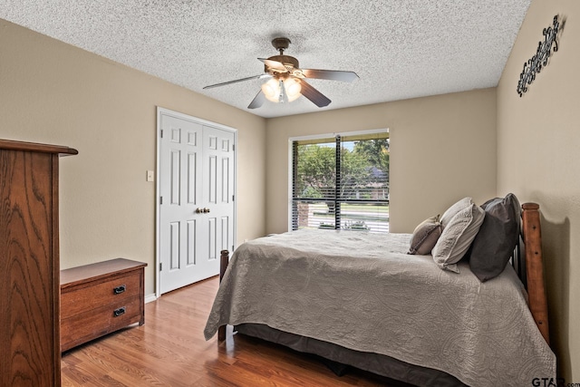 1801 N Fairway, Mount Pleasant, TX 75455 - bedroom featuring wood finished floors, a textured ceiling, ceiling fan, and a closet