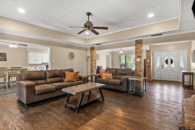 1801 N Fairway, Mount Pleasant, TX 75455 - living room featuring decorative columns, a ceiling fan, dark wood-type flooring, a textured ceiling, and ornamental molding