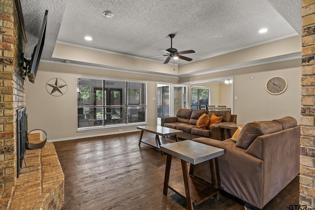 1801 N Fairway, Mount Pleasant, TX 75455 - living area with a textured ceiling, a ceiling fan, wood finished floors, a brick fireplace, and recessed lighting