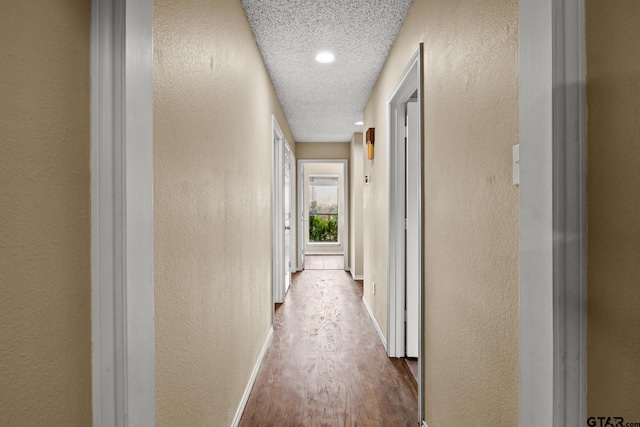 1801 N Fairway, Mount Pleasant, TX 75455 - hall featuring wood finished floors, a textured wall, and a textured ceiling