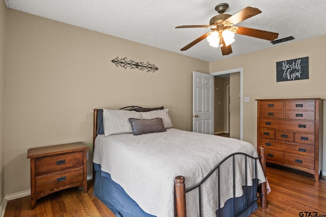 1801 N Fairway, Mount Pleasant, TX 75455 - bedroom featuring wood finished floors, a textured ceiling, and ceiling fan