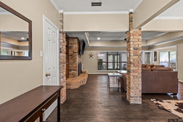 1801 N Fairway, Mount Pleasant, TX 75455 - living room featuring wood finished floors, healthy amount of natural light, a brick fireplace, crown molding, and a textured ceiling