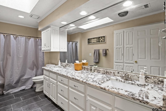 1801 N Fairway, Mount Pleasant, TX 75455 - full bath featuring double vanity, recessed lighting, ornamental molding, a skylight, and tile patterned flooring