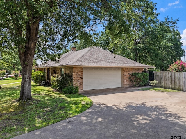 1801 N Fairway, Mount Pleasant, TX 75455 - view of front of home with brick siding, concrete driveway, an attached garage, a chimney, and a shingled roof